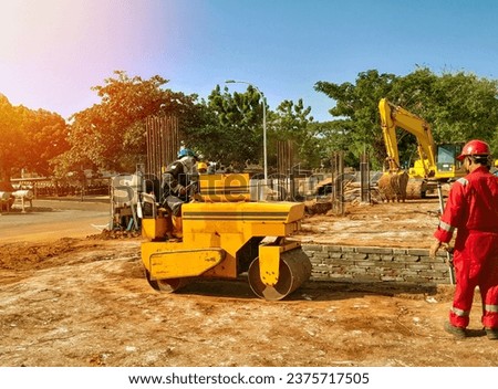 a engineer control  of soil compactor for leveling ground for foundation construction. Foundation compaction equipment at construction site. Building construction.
