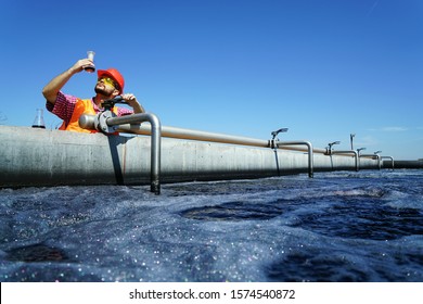                An engineer controlling a quality of water ,aerated activated sludge tank at a waste water treatment plant.  pollution                                 