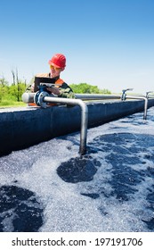An Engineer Controlling The Quality Of Water , Aerated Activated Sludge Tank At A Waste Water Treatment Plant
