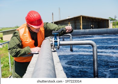 An engineer controlling a quality of water ,aerated activated sludge tank at a waste water treatment plant