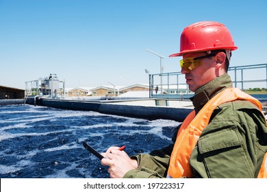 An engineer controlling a quality of water ,aerated activated sludge tank at a waste water treatment plant