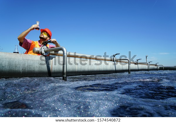                An\
engineer controlling a quality of water ,aerated activated sludge\
tank at a waste water treatment plant.  pollution                  \
              