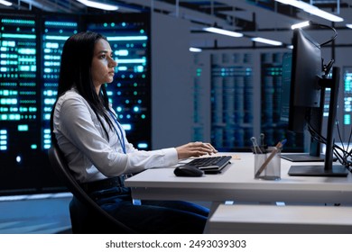 Engineer in data center checking equipment performance on PC after installing and upgrading hardware components such as servers, storage devices, and networking equipment