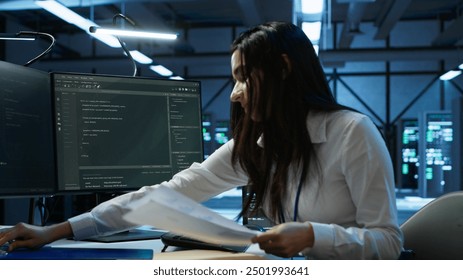 Engineer in data center installing software on computer, helping maintain network, troubleshooting arising issues. IT expert in server room establishing performance benchmarks, camera A