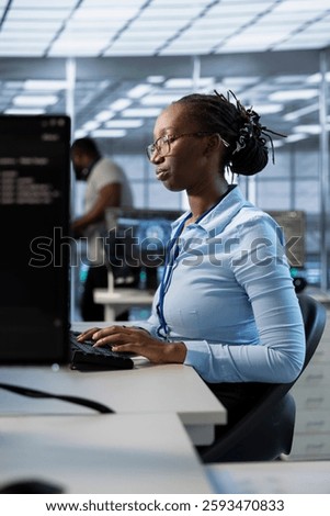 Engineer in data center managing and optimizing large scale IT infrastructure, using network management skills. Server room worker upgrading equipment, reducing operational costs