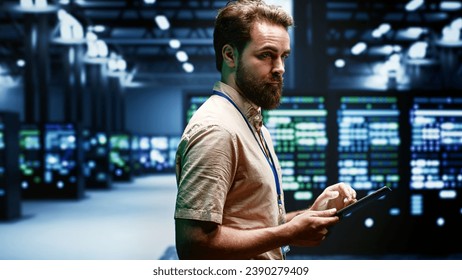 Engineer in data center using renewable solar and wind energy sources to power crypto mining operations. Expert working with eco friendly server clusters preventing significant environmental impact - Powered by Shutterstock