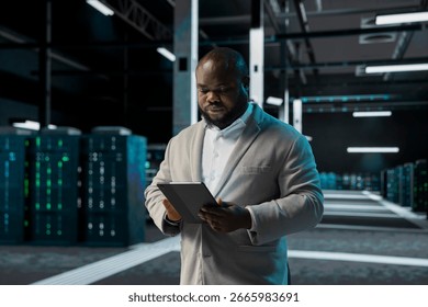 Engineer in data center using tablet to check for server performance issues arising due to high CPU usage. Server room worker fixing insufficient memory errors slowing down hardware