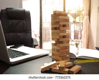 Engineer Desk With A Blocks Wood Tower Game. Plan Construction Project Concept.