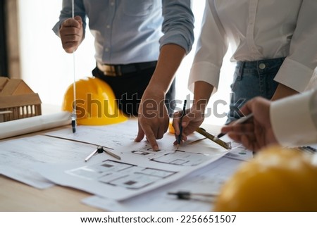 Engineer and Developers Gathered Around Finding Solution and Analysing Industrial Engine Design. Close-up Hands Shot.