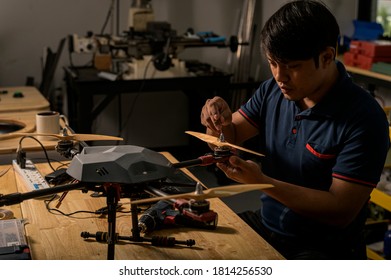 Engineer developing on drone in workshop.