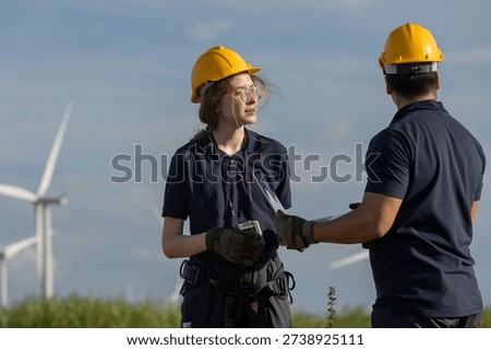 Engineer discussing field operations at wind farm, highlighting teamwork, safety, and the professional planning behind clean and sustainable renewable energy development.