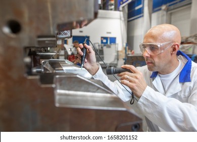 Engineer Doing Maintenance On A Injection Mold For Plastic Components, Industrial And Automotive Concept