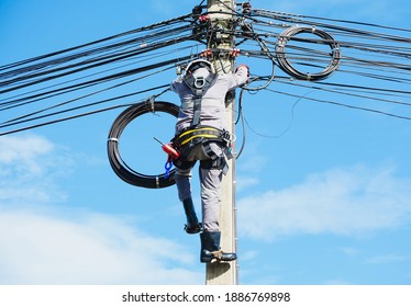 Engineer Or Electrician Working On Checking And Inspection Equip On The Electric Pole During Repair Wearing Equipment Safety Harness Full Body