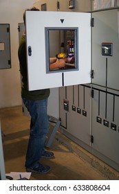 Engineer or electrician working on checking and maintenance equipment. 