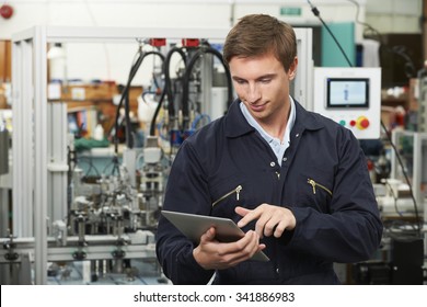 Engineer In Factory Using Digital Tablet