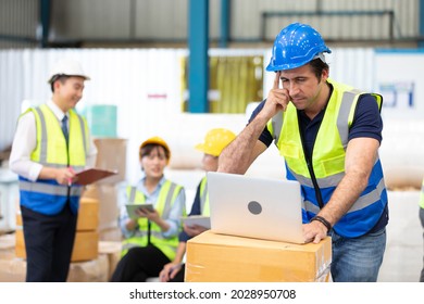 Engineer Or Factory Worker Using Laptop Computer And Thinking Of Something Seriously In Warehouse Storage