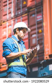 Engineer or foreman holding tablet and wears PPE to checking inventory or job details in the tablet with cargo container background. Engineering site and working with technology concept. - Shutterstock ID 1922080529