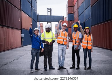 Engineer and foreman team stand to celebrating or raise their hands together at cargo containers. - Shutterstock ID 2278246357