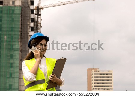 engineer or foreman using smart phone in her job with in construction site
