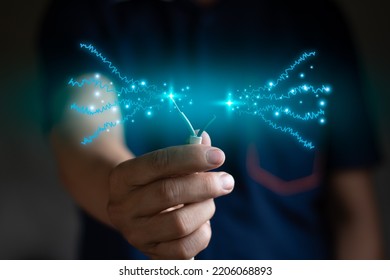 A engineer hand catch electricity wire blur background, computer graphic light, renewable power and energy , save energy concept blue style copy space for text - Shutterstock ID 2206068893