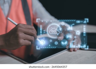 Engineer hand using computer and pen with virtual modern reduce co2 emission concept with icons global warming emissions carbon footprint climate change to limit global warming energy