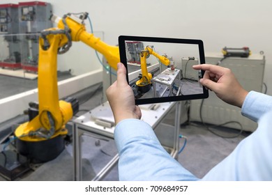 Engineer Hand Using Tablet, Heavy Automation Robot Arm Machine In Smart Factory Industrial With Tablet Real Time Monitoring System Application. Industry 4th Iot Concept.