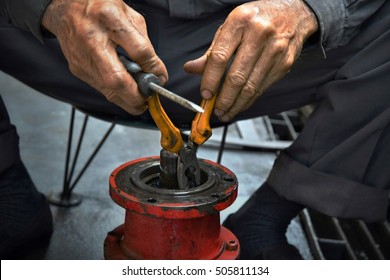 Engineer hands fixing engine hydraulic power transmission gears box