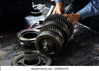 Engineer hands fixing engine power transmission gears box