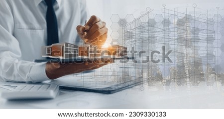 Engineer hands holding digital tablet with house construction project planning, House designer and digital technology.