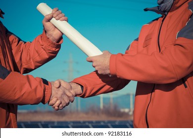 Engineer Handshake with Plans Delivery