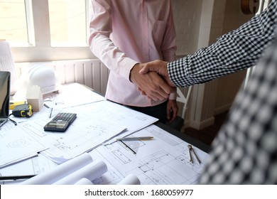 engineer handshaking. architect shaking hands for successful deal in building construction project. teamwork cooperation concept