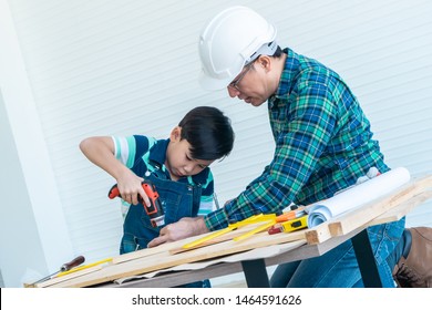 Engineer Handy Man Father Is Teaching His Boy To Use Electric Driller On Wood