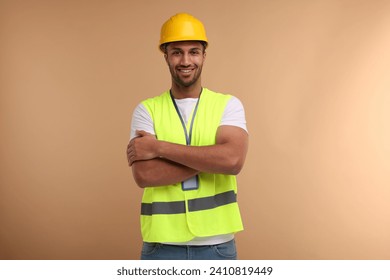 Engineer with hard hat and badge on beige background - Powered by Shutterstock