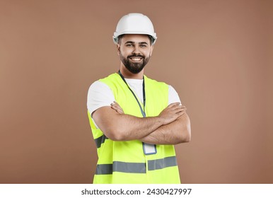 Engineer with hard hat and badge on brown background - Powered by Shutterstock