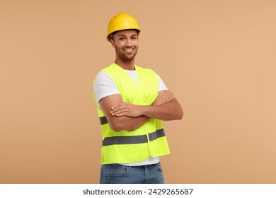 Engineer in hard hat on beige background - Powered by Shutterstock