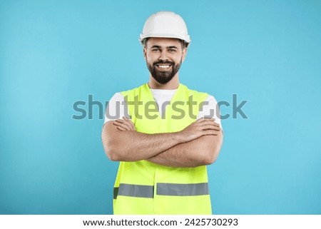 Engineer in hard hat on light blue background