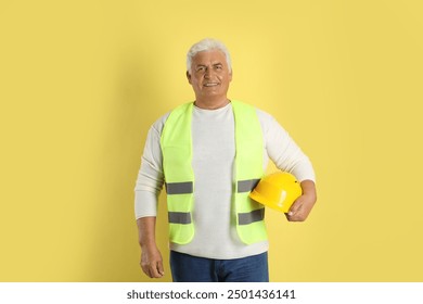 Engineer with hard hat on yellow background - Powered by Shutterstock