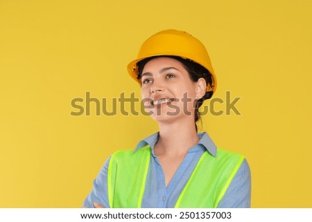 Engineer in hard hat on yellow background, space for text