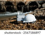 Engineer Hardhat and connected water sampling device equipment appears to collecting or analyzing data the water quality industrial wastewater discharged into natural water concept.