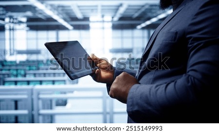 Engineer in high tech facility using tablet to patch network issues leading to slow data transfer rates. Close up of worker fixing errors affecting servers performance and connectivity, camera B