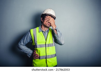 Engineer In High Vis Covering His Face  