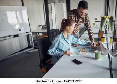 Engineer and his coworker creating a technical drawing