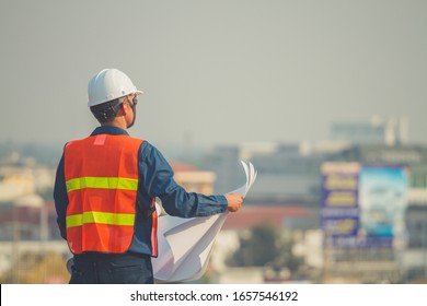 Engineer Hold Blue Prints Looking Forward With Hope And Keep Going At Construction Site.