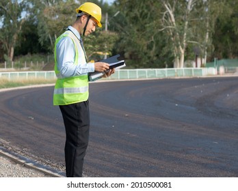 Engineer Holding Blueprints To Review Construction Drawings (focus On Hand)