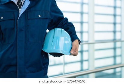 Engineer holding a helmet. Construction worker. Disaster prevention.