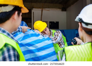 Engineer Holding A Radio To Report The Work Of A Construction Worker Sleeping On The Job Site. Industrial Concept Of Building Construction Projects. Labor Welfare. Labor Insurance