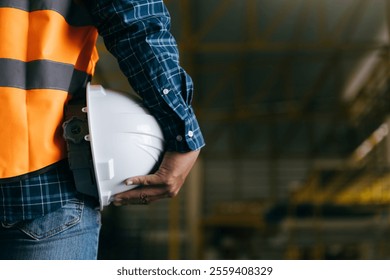 Engineer holding worker helmets hardhat in construction site, Civil engineering concept.