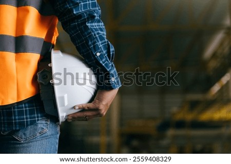 Engineer holding worker helmets hardhat in construction site, Civil engineering concept.