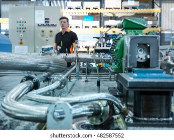 Engineer with industrial pump testing rig in factory