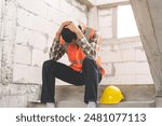 Engineer industry unemployed. Feeling stress, tired and headache asian man sitting depressed on stair at site, worker male crisis in factory, fired unemployment from economy, lost job, jobless concept